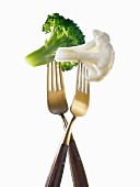 "Two forks with broccoli and cauliflower ;light lunch"