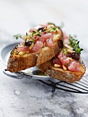 Raw tuna, black olive, thyme and pine nut open sandwich