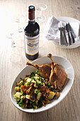 Duck Confit with sauteed potatoes with parsley and a bottle of Bordeaux wine
