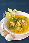 Dog cockel shellfish saffron soup with leeks, peas and beans