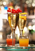 Glasses of Champagne and redcurrant and orange cocktail