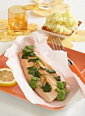 Trout fillet with watercress and broad beans cooked in greaseproof paper