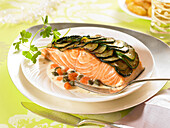 Thick piece of salmon covered with zucchini scales