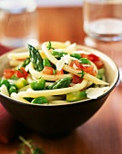 Spaghetti with green asparagus, broad beans and diced tomatoes