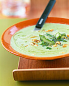 Cream of asparagus soup with crushed walnuts