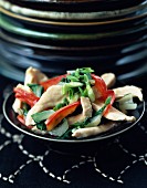Sliced chicken breasts in cream with red peppers and Bok choy