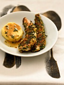 Sliced chicken breasts in breadcrumbs and herbs
