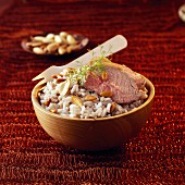 Sliced leg of lamb with pilaf rice and dried fruit