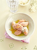 Sweet pink quenelles with elderflower syrup and orange zests