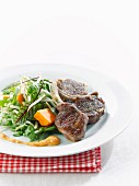 Lamb chops with salad, tomato and paprika sauce
