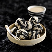 Beef meatballs coated with golden and black sesame seeds