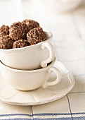 Chocolate truffles coated with crushed praline and sesame seeds