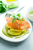Thick piece of salmon grilled on one side with sorrel sauce