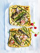 Small sardine and green bean pizzas