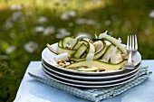 Tagliatelles-shaped zucchini, cheese and pine nut salad