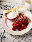 Portion of strawberry tart with cream
