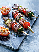 Beef and vegetable brochettes and provençal-style tomatoes