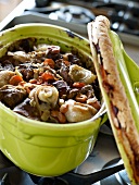 Beef,carrot and onion stew served in a casserole dish sealed with dough
