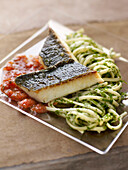 Piece of bass with tomato puree and spaghettis with herbs