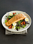 Grilled salmon steak and mixed salad with quail's eggs
