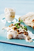 Cod with olives cooked in wax paper