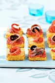 Squares of polenta with anchovies