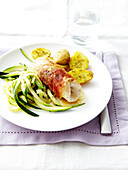 Rolled turkey fillet with prosciutto and parmesan,zucchinis and potatoes with rosemary