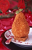 Poached pear coated in gingerbread crumbs