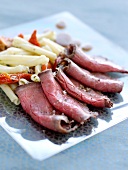 Cold roast beef and macaronis with sun-dried tomatoes
