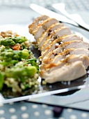 Sliced chicken breast with bulghour tabbouleh with asparagus