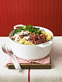 Tubettis with meat, red onions, cheese and coriander in a casserole dish