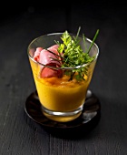 Carrot flan with sliced duck's breast and herbs