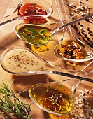 Spoonsful of different types of sauces and vinaigrettes