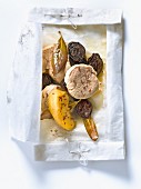 Filet mignon with apples,prunes,mustard seeds and bay leaves cooked in wax paper