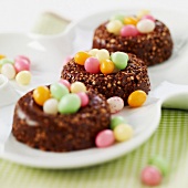 Crunchy chocolate nests filled with multicolored sugar Easter eggs