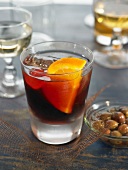 Bunueloni cocktail with Campari, gin, orange and candied cherry