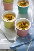Small vanilla-flavored Crèmes caramel topped with crushed pistachios