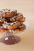 Donuts coated with chocolate and pistachios