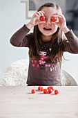 Young girl playing with cherry tomatoes