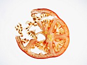 Thin slice of tomato on a white background