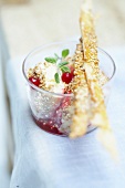 Yoghurt and sesame seed ice cream with redcurrant puree and crisp biscuits