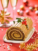 Christmas coffee log cake decorated with holly
