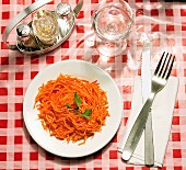 Plate of grated carrots on a table in a Brasserie