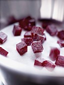 Squares of fruit paste coated in sugar