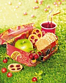 Cherry tartlets,waffles and an apple in a lunch box