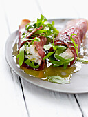Bresaola rolls stuffed with rocket lettuce,cheese and basil