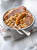 White beans in tomato sauce with salt-pork and sausages