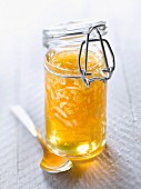 Small jar of honey with coconut