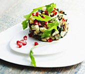 Zucchini, eggplant and pomegranate seed Timbale