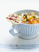 Pistou soup with Grana padano and coppa tuiles